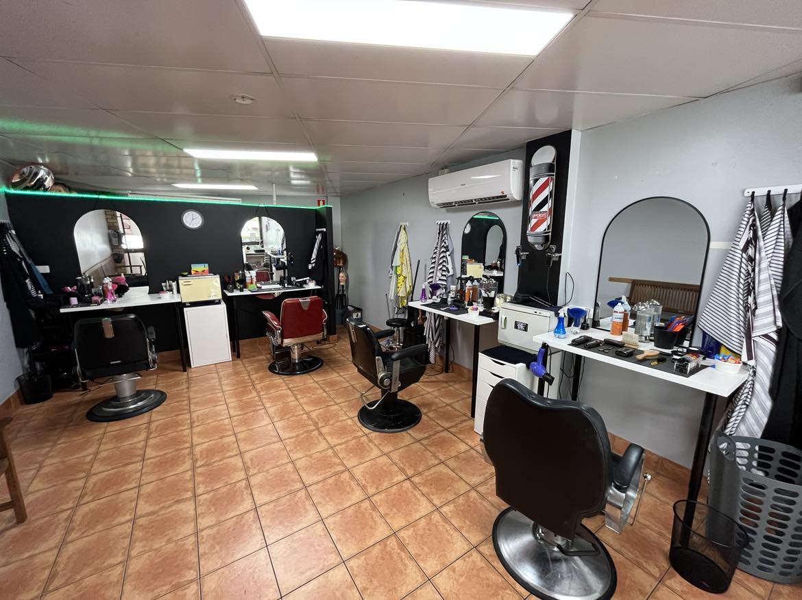 Inside Caboolture Barbershop with the red and white barber pole on the wall