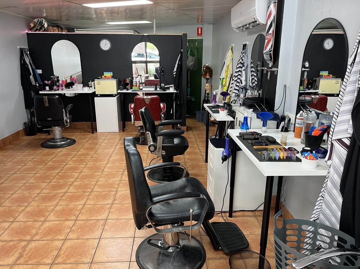 The full row of chairs and stations inside the shop
